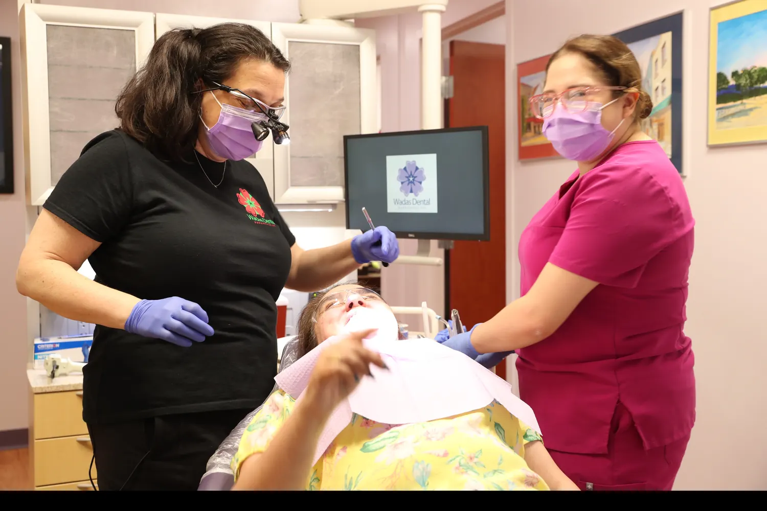 A Wadas Dental dentist and assistant with a patient in the treatment room